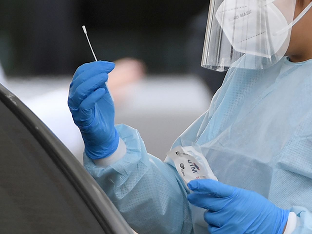 A medical worker conducts a test for COVID-19 at a drive-up testing station in the parking lot of UNLV Medicine on Monday, April 6, in Las Vegas, Nevada. 