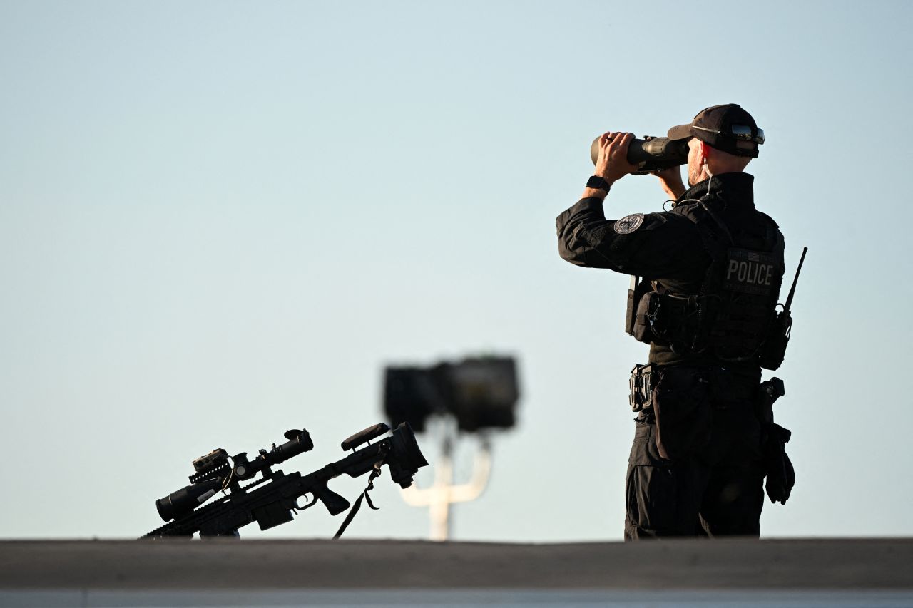 A Secret Service sniper team member stands guard as he waits for Donald Trump to arrive at Philadelphia International Airport in Philadelphia, Pennsylvania, on September 10.