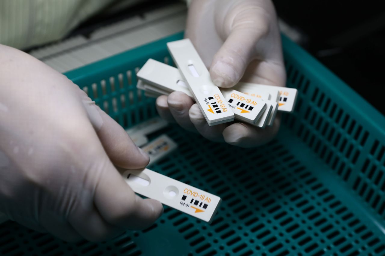 An employee holds coronavirus test kits at the Boditech Med Inc. headquarters on April 17, in Chuncheon, South Korea.