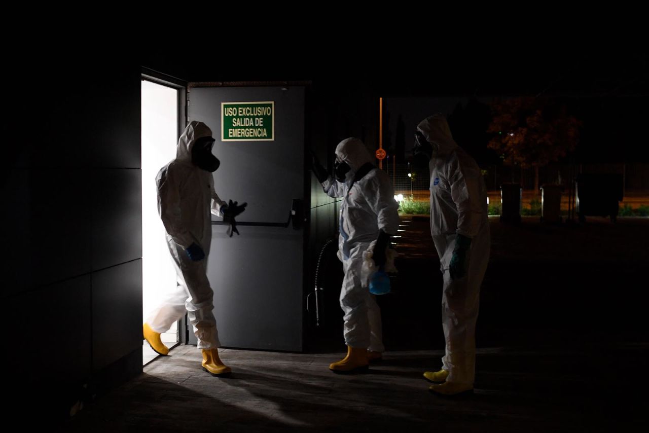 Members of the Spanish Military Emergencies Unit wearing protective gear prepare to disinfect the Lope de Vega Cultural Center in the Vallecas neighborhood where rapid tests for Covid-19 were conducted to residents of the area, on September 30 in Madrid.