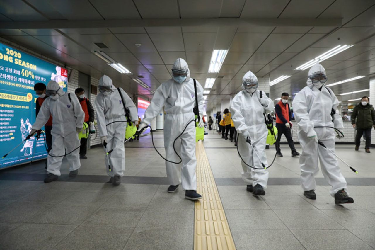 Workers wearing protective gear disinfect as a precaution against coronavirus at a subway station in Seoul on Wednesday, March 11.