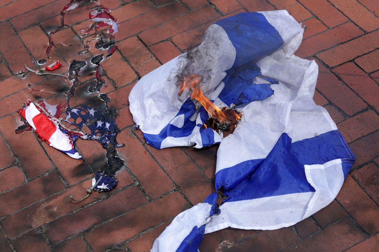 A burned US flag and Israeli flag are seen during a pro-Palestinian protest near the US Capitol.