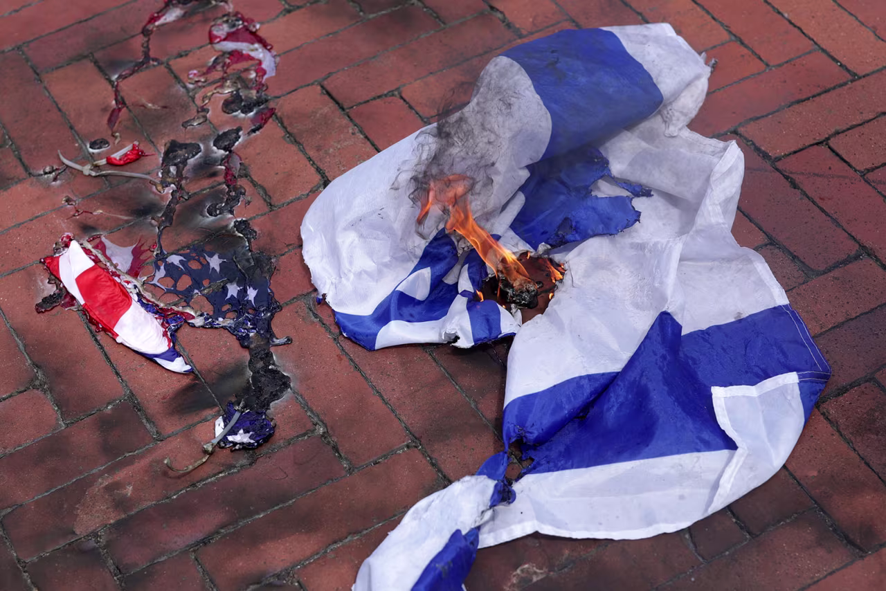 A burned US flag and Israeli flag are seen during a pro-Palestinian protest near the US Capitol.