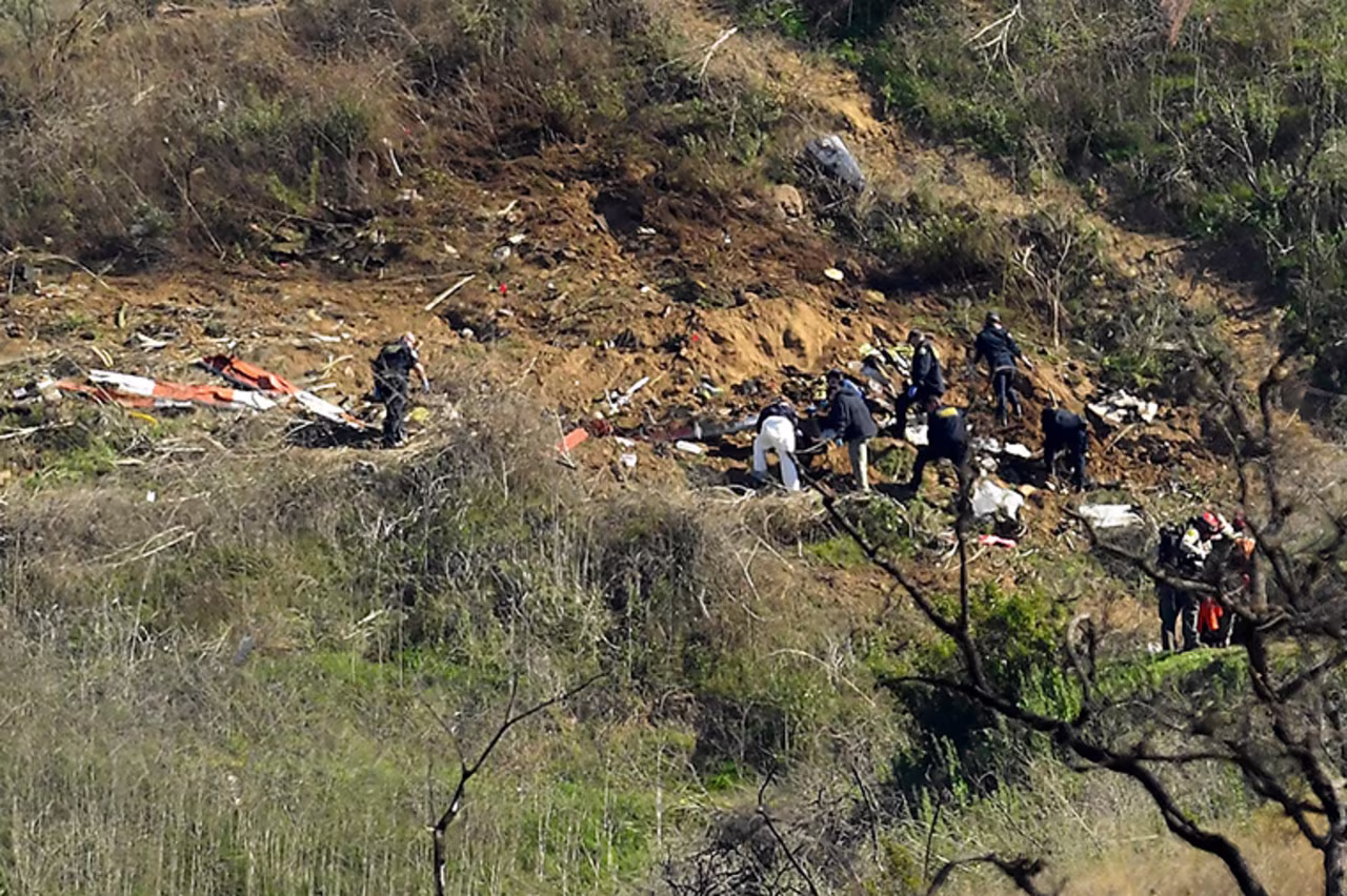 Investigators work the scene of the crash on Monday, January 27. 