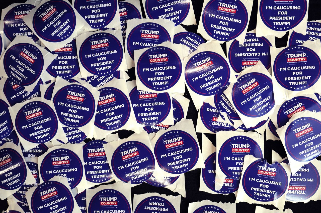 Campaign stickers sit on a table during a rally with former President Donald Trump in Indianola, Iowa, on Sunday.