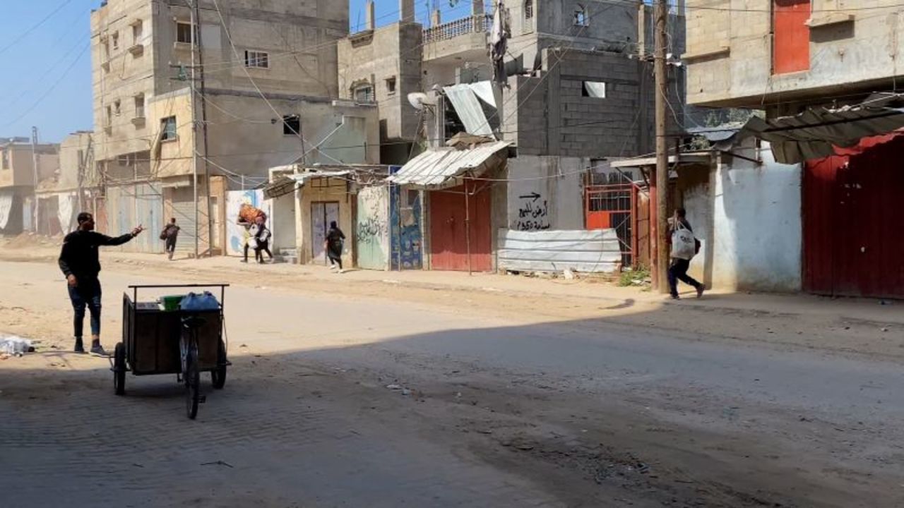 People run with their belongings following a strike in Nuseirat on Friday.