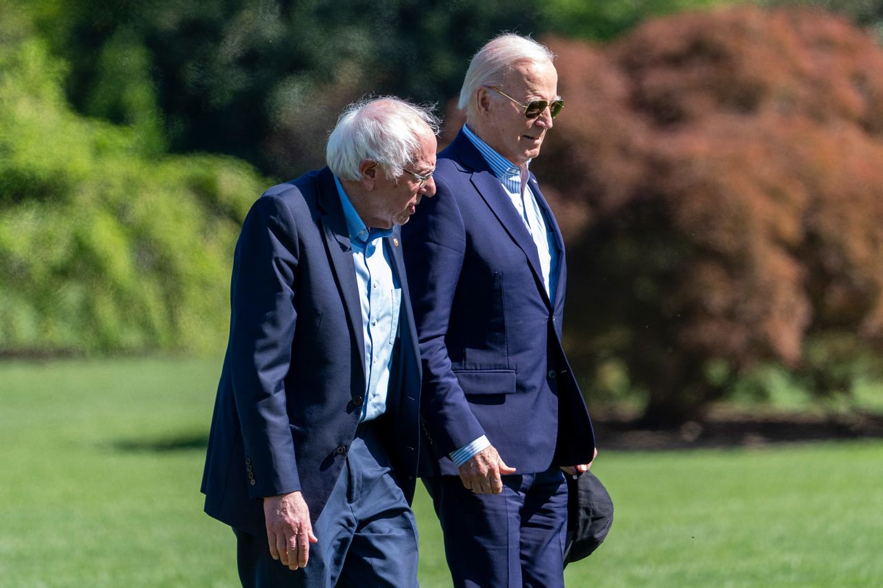 Sen. Bernie Sanders and President Joe Biden walk on the South Lawn of the White House on April 22, in Washington, DC. 