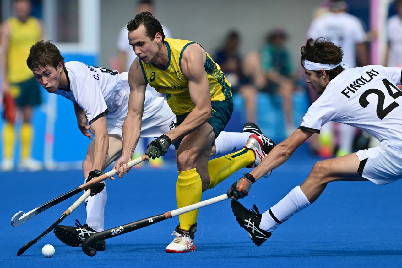 Australia's forward #02 Thomas Craig (C) is marked by New Zealand's midfielder #24 Sean Findlay and New Zealand's defender #08 Charlie Morrison in the men's pool B field hockey match between New Zealand and Australia at the Yves-du-Manoir Stadium in Colombes on August 1. 