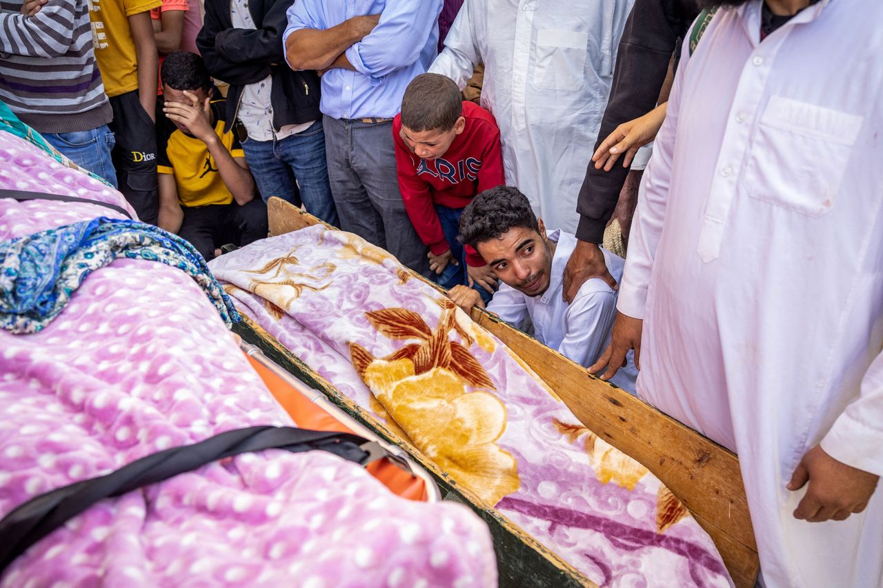 People mourn in front of the bodies of earthquake victims in Moulay Brahim, Morocco on September 9.