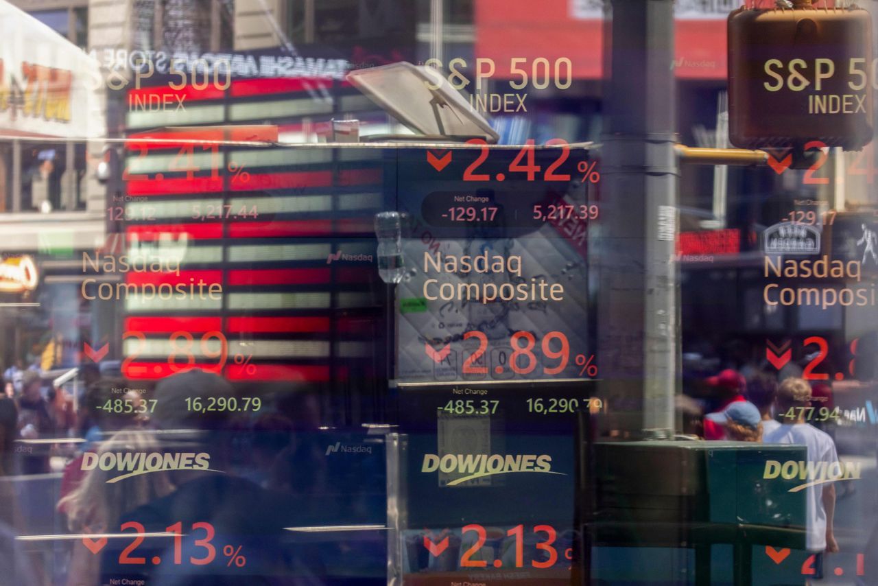 Stock market information is seen displayed at the Nasdaq MarketSite in New York, on Monday, August 5.