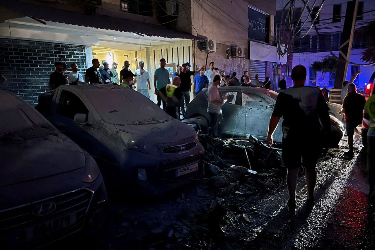 People inspect damaged cars in the southern suburbs of Beirut on Tuesday.