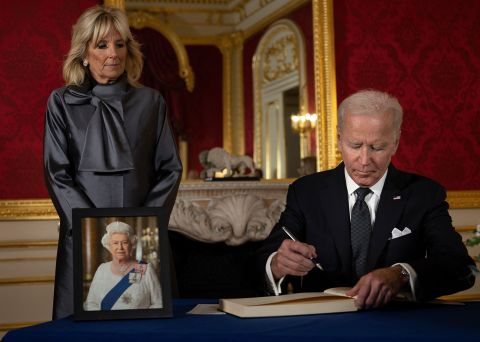 US President Joe Biden, watched by first lady Jill Biden, signs a book of condolence at Lancaster House in London on September 18.