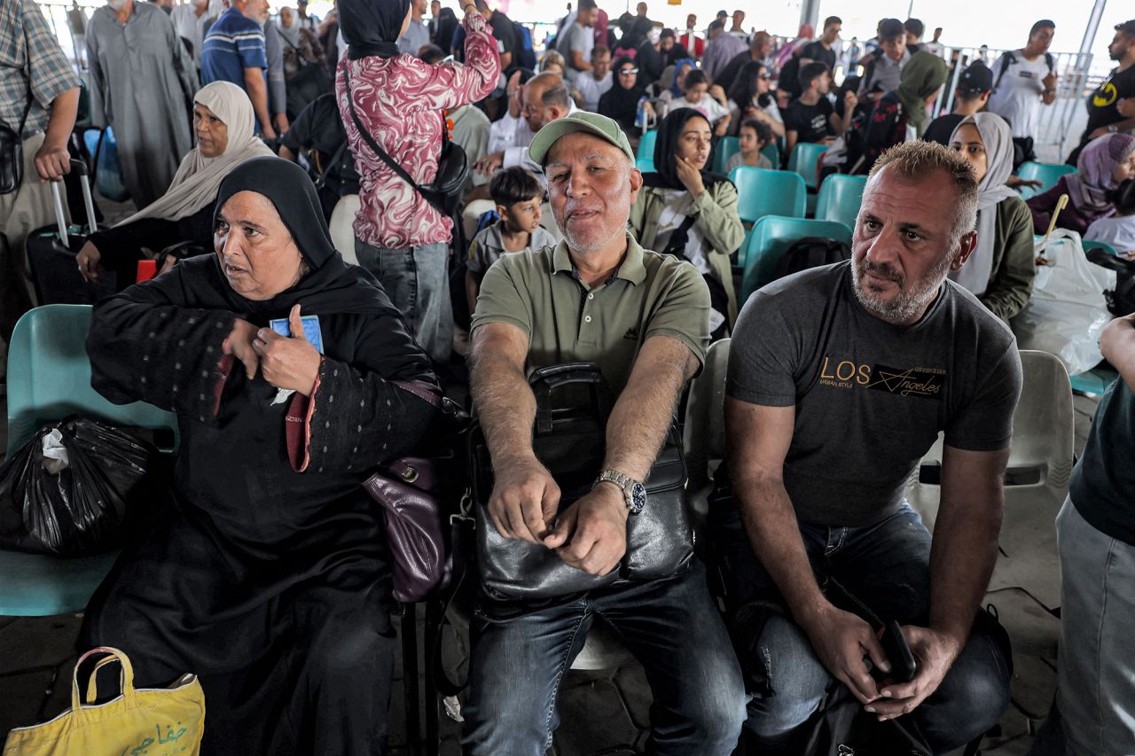 People sit in a waiting area at the Rafah border crossing on Wednesday.