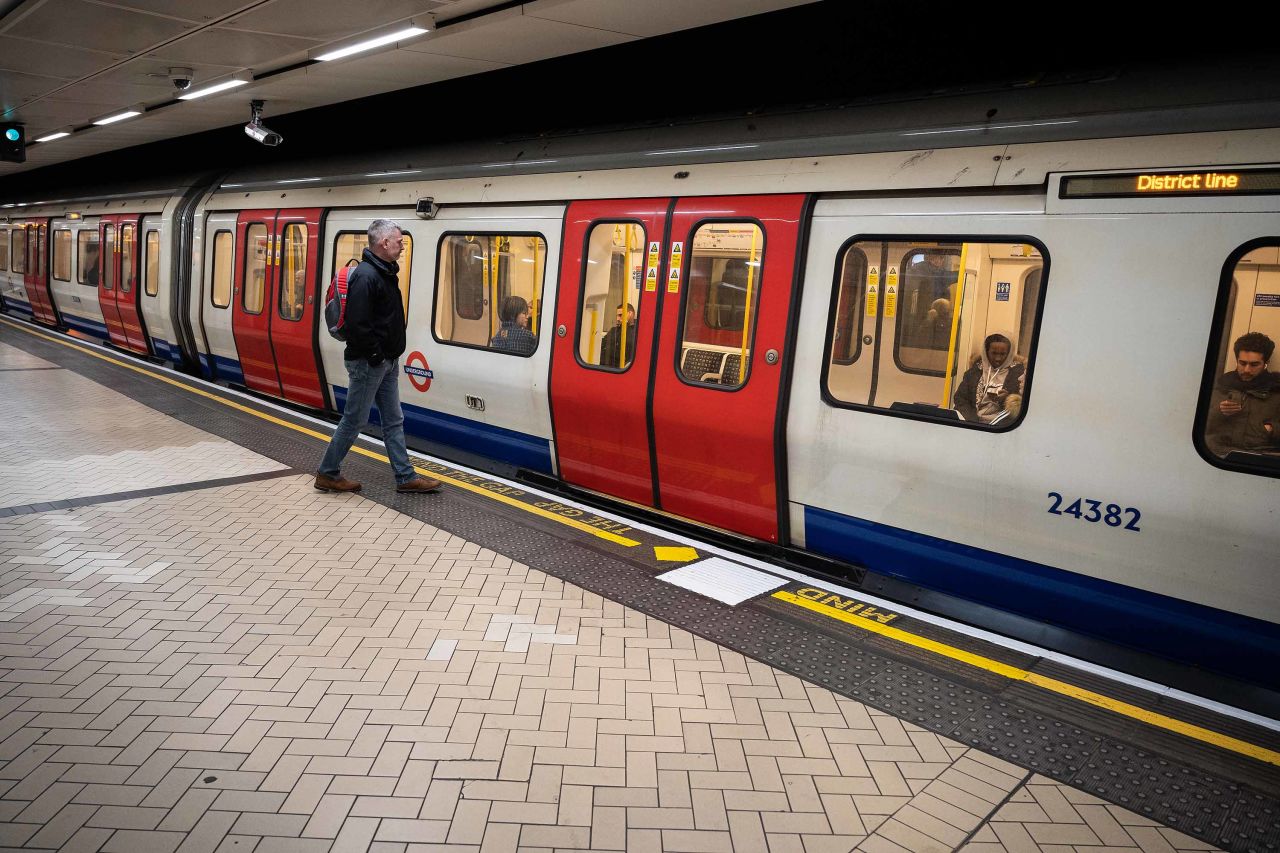 A commuter boards an underground train during rush-hour in London, England, on March 18.