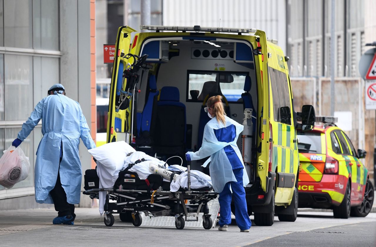 Health workers transfer a patient from an ambulance into The Royal London Hospital in London on April 18.