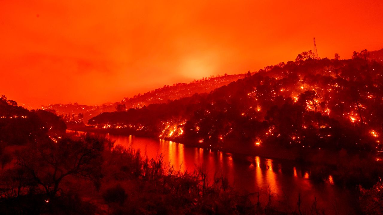 Flames are seen on both sides of Lake Berryessa in this long-exposure photo taken in Napa, California, on Tuesday.