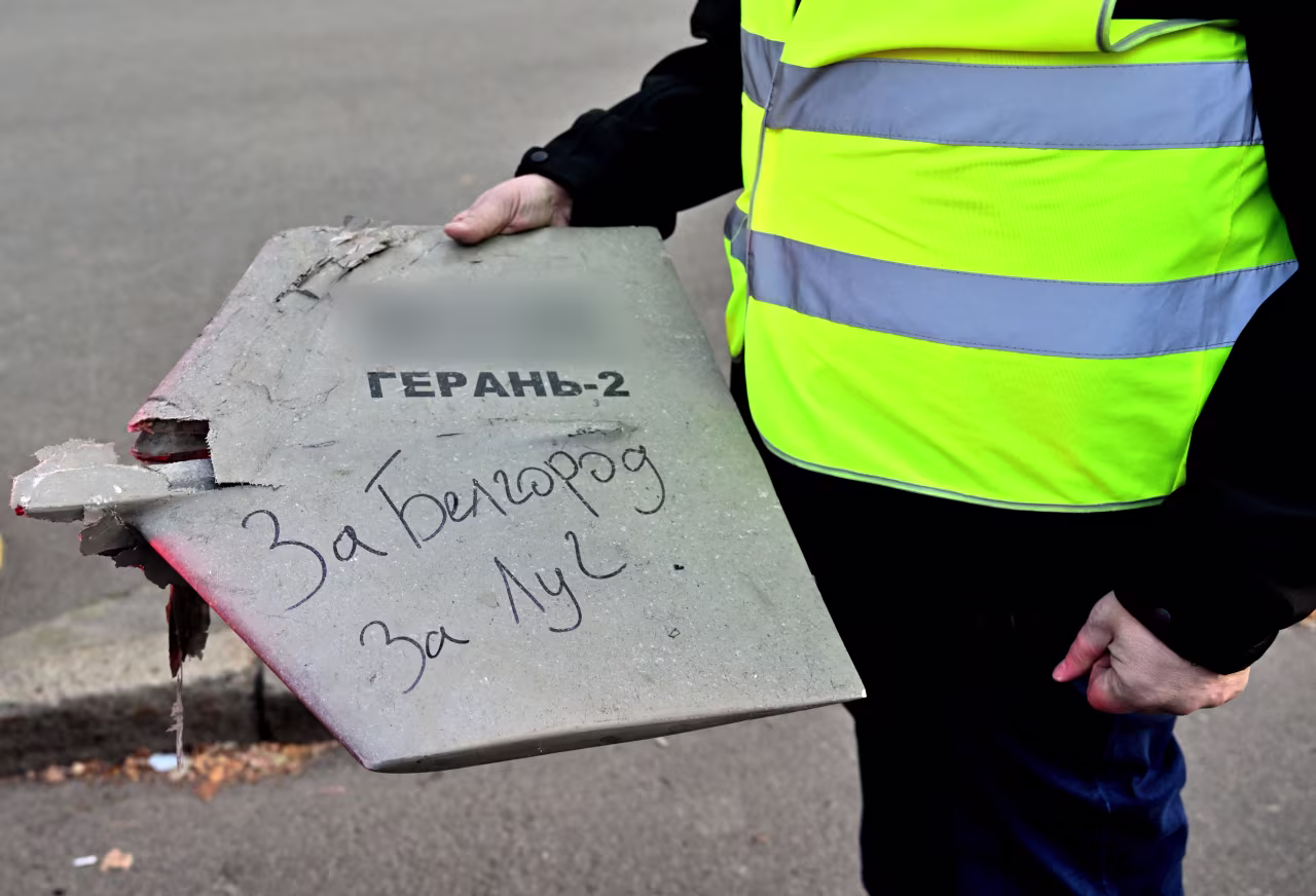 A police expert holds a fragment of a drone with a handwritten inscription reading "For Belgorod. For Luch" after a drone attack in Kyiv on October 17. Image has been blurred by CNN because the identifier could help Russian targeting.