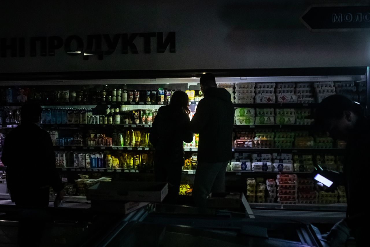 People shop at a supermarket during a power outage in Kyiv on October 27.