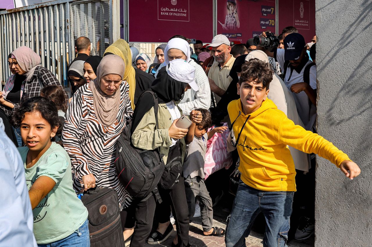 People walk through a gate to enter the Rafah border crossing in Gaza on November 1.