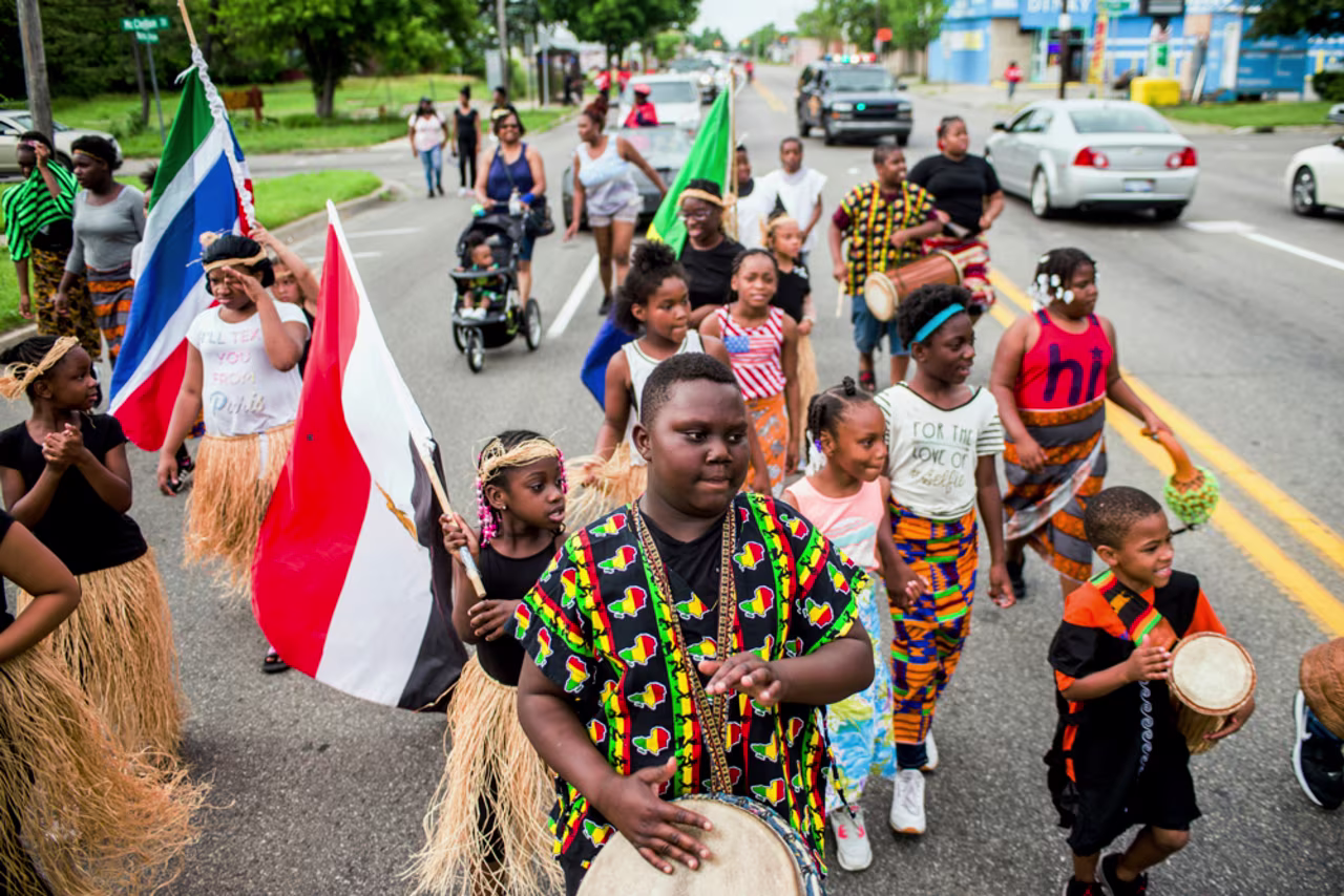 In this June 19, 2018 file photo, Zebiyan Fields drums alongside more than 20 kids at the front of the Juneteenth parade in Flint, Michigan.