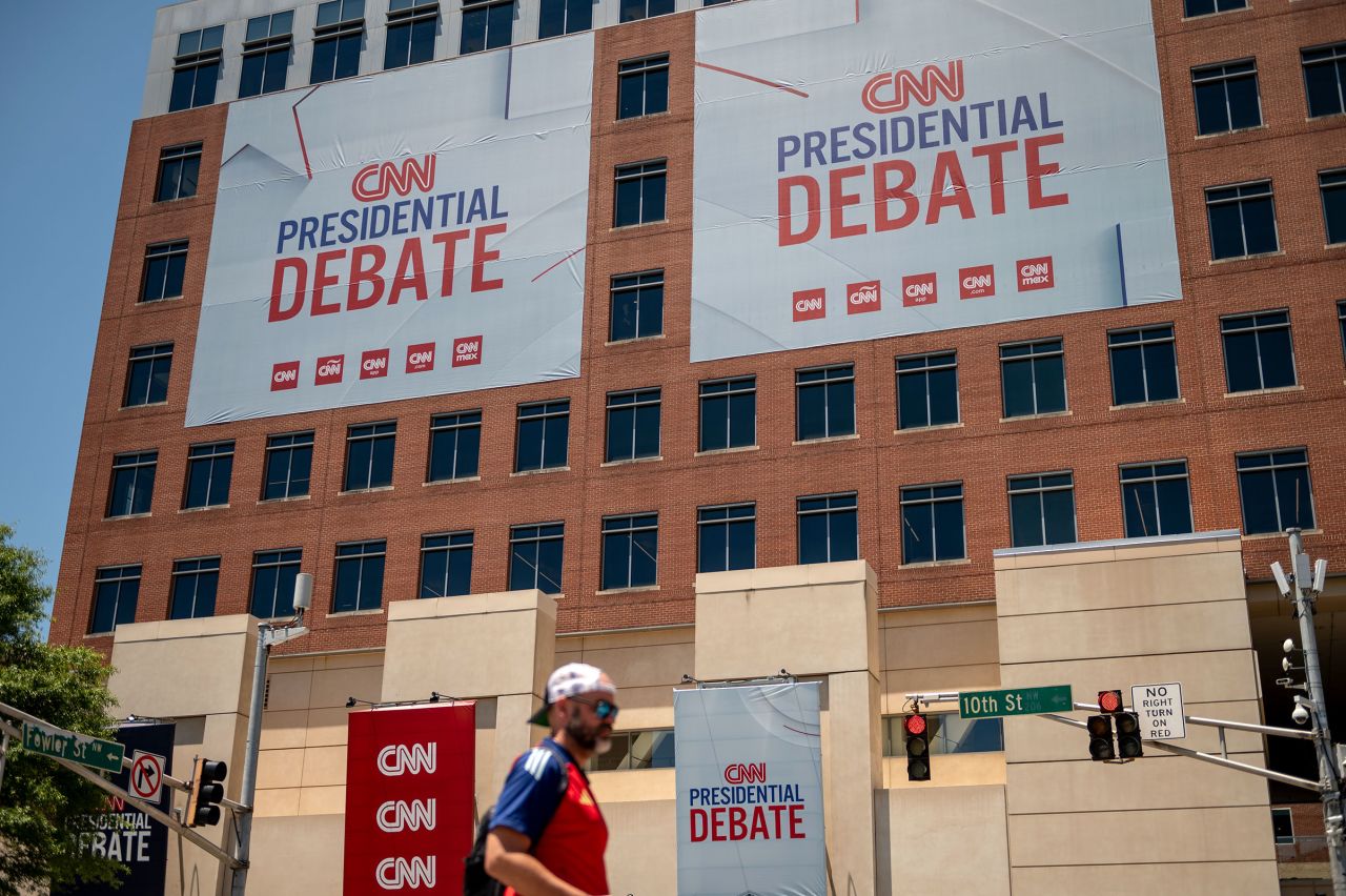 Banners hang outside of CNN’s Atlanta headquarters ahead of CNN’s Presidential Debate between President Joe Biden and former President Donald Trump on Monday, June 24.