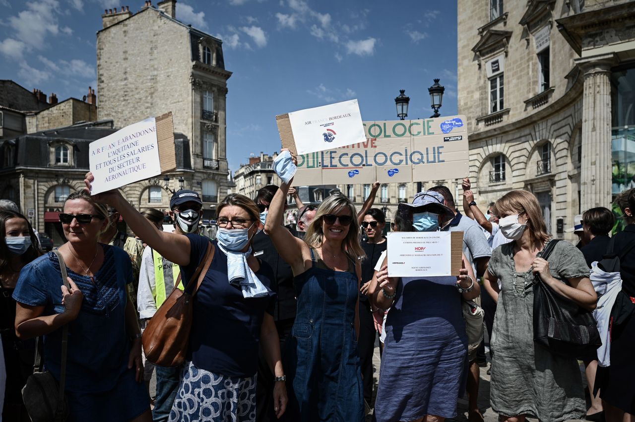 Women hold signs as HOP! and Air France employees protest against the end of the air shuttle service between Bordeaux-Mérignac and Paris-Orly outside Air France offices in Bordeaux, south-western France, on Friday, July 30. 