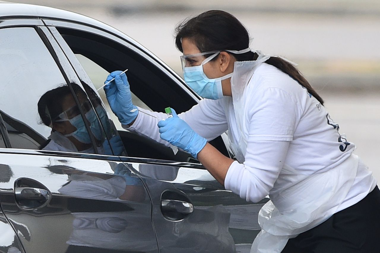 A medical worker tests an NHS worker for Covid-19 at a drive-in testing facility in Greater London on April 18.