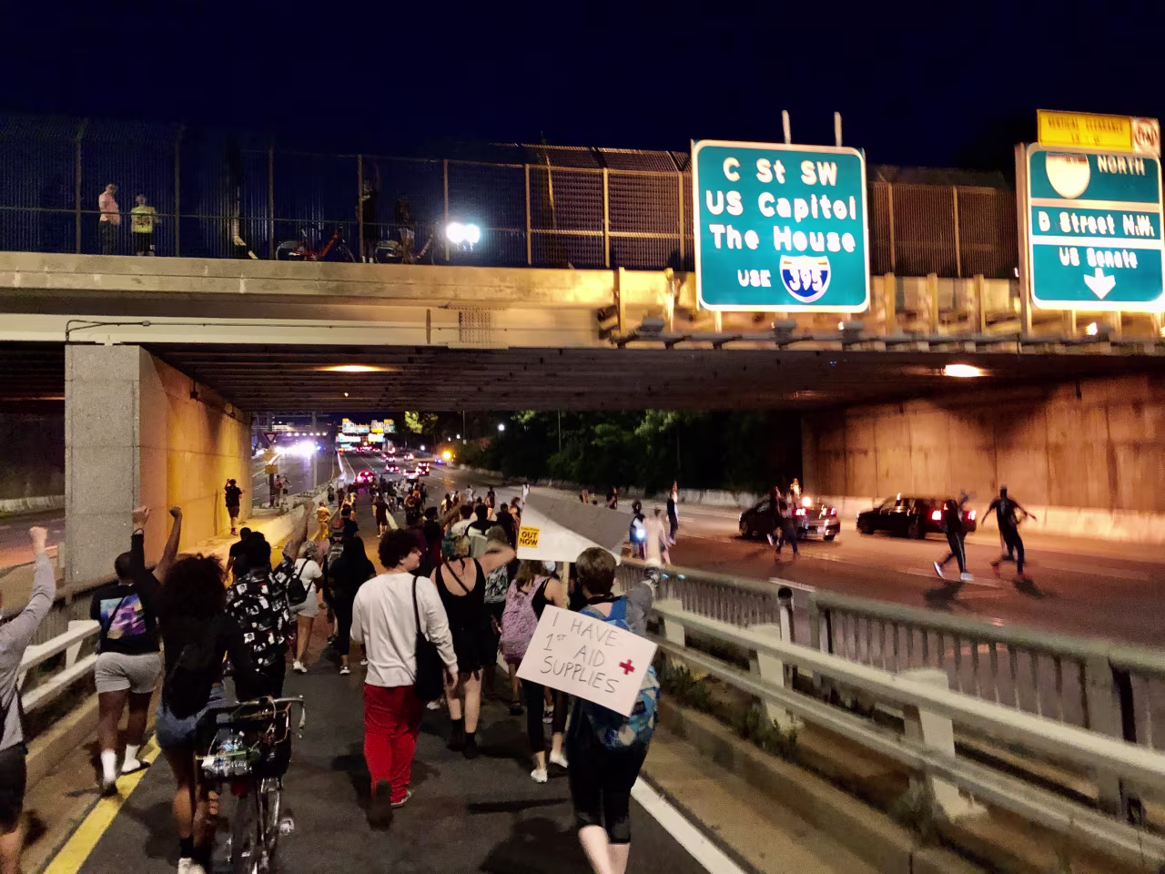 Protesters march through a tunnel which leads to a highway in DC. 