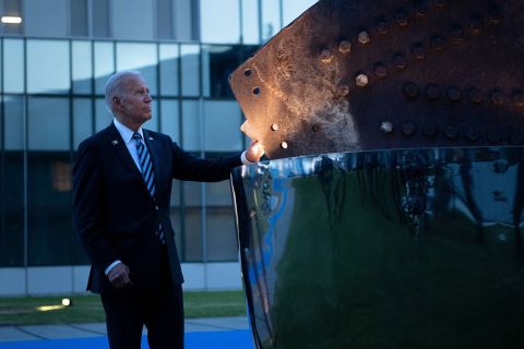 President Joe Biden touches a memorial for the September 11 terrorist attacks on the United States after a summit June 14, at NATO Headquarters in Brussels.