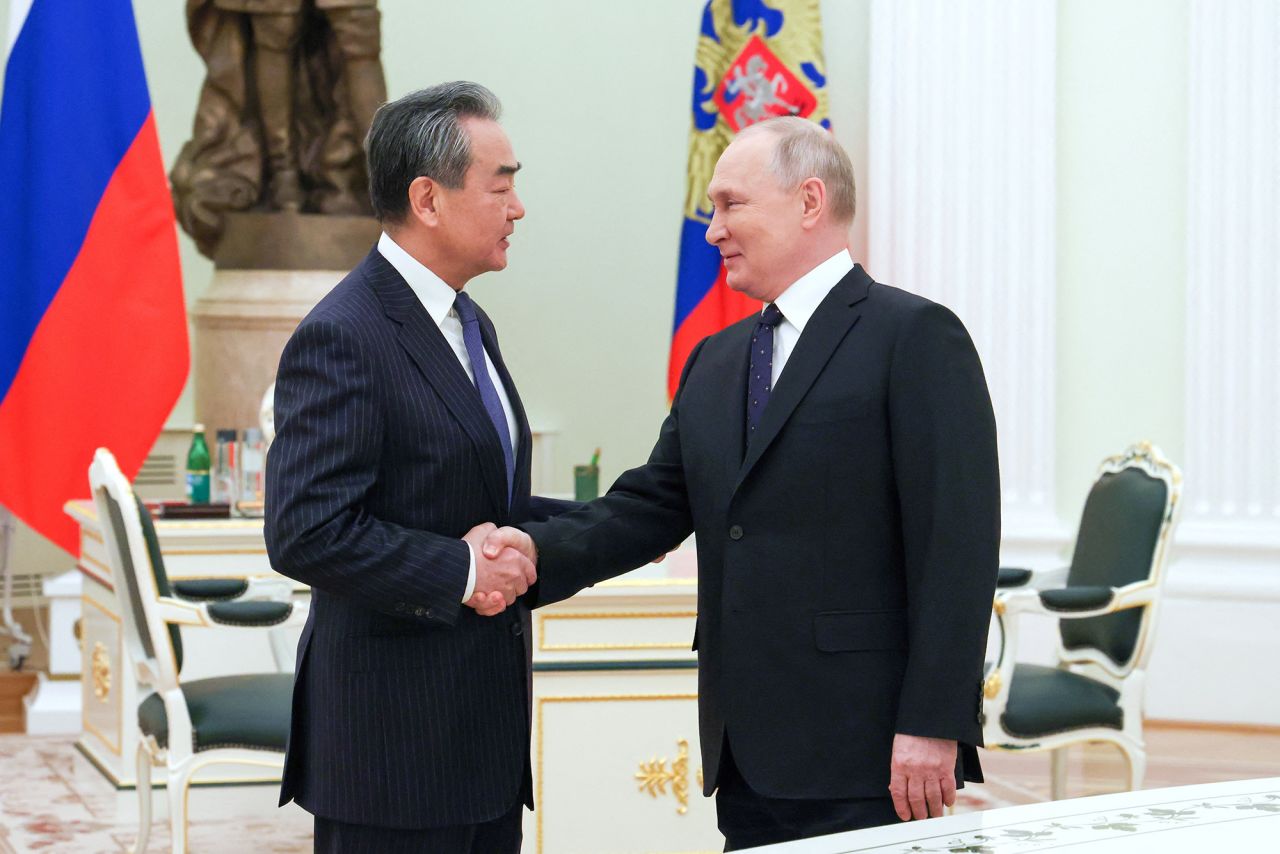 Russia's President Vladimir?Putin, right,?shakes hands with China's Director of the Office of the Central Foreign Affairs Commission Wang Yi during a meeting in Moscow, Russia, on February 22.