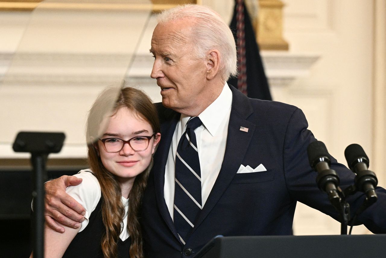 US President Joe Biden embraces Miriam Butorin, the daughter of Aslu Kurmasheva, at the White House on Thursday.