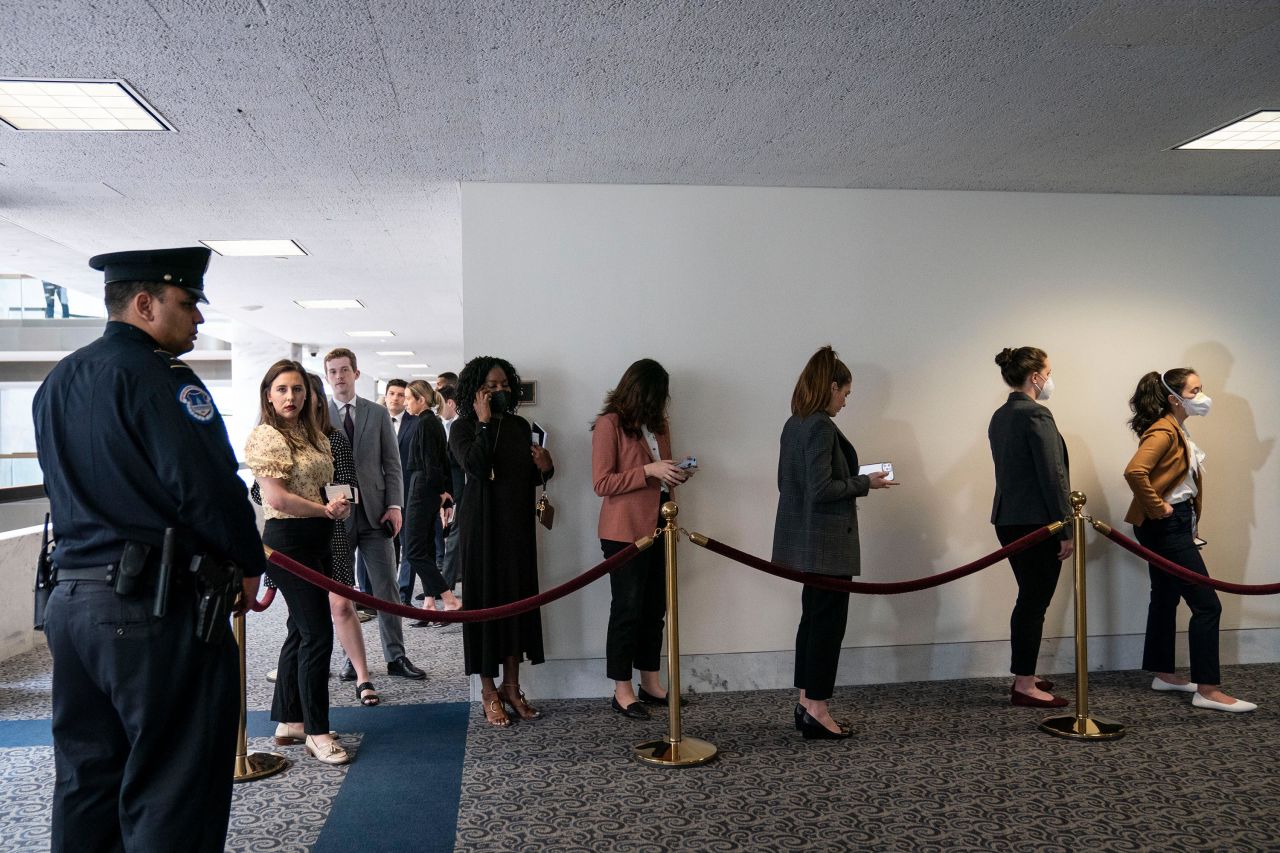 People wait in line for a chance to sit in during the hearings on Tuesday.