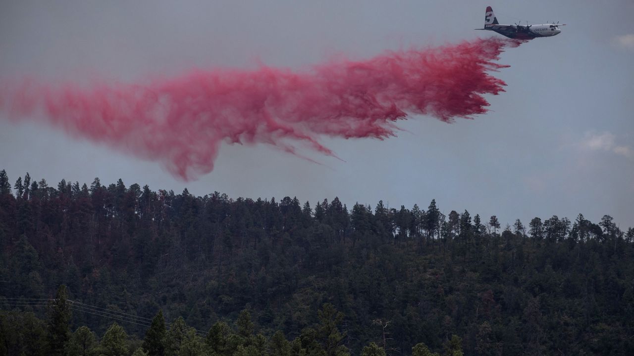 An airtanker drops fire retardant over the Salt fire as it nears the town of Ruidoso, New Mexico, on June 19. 