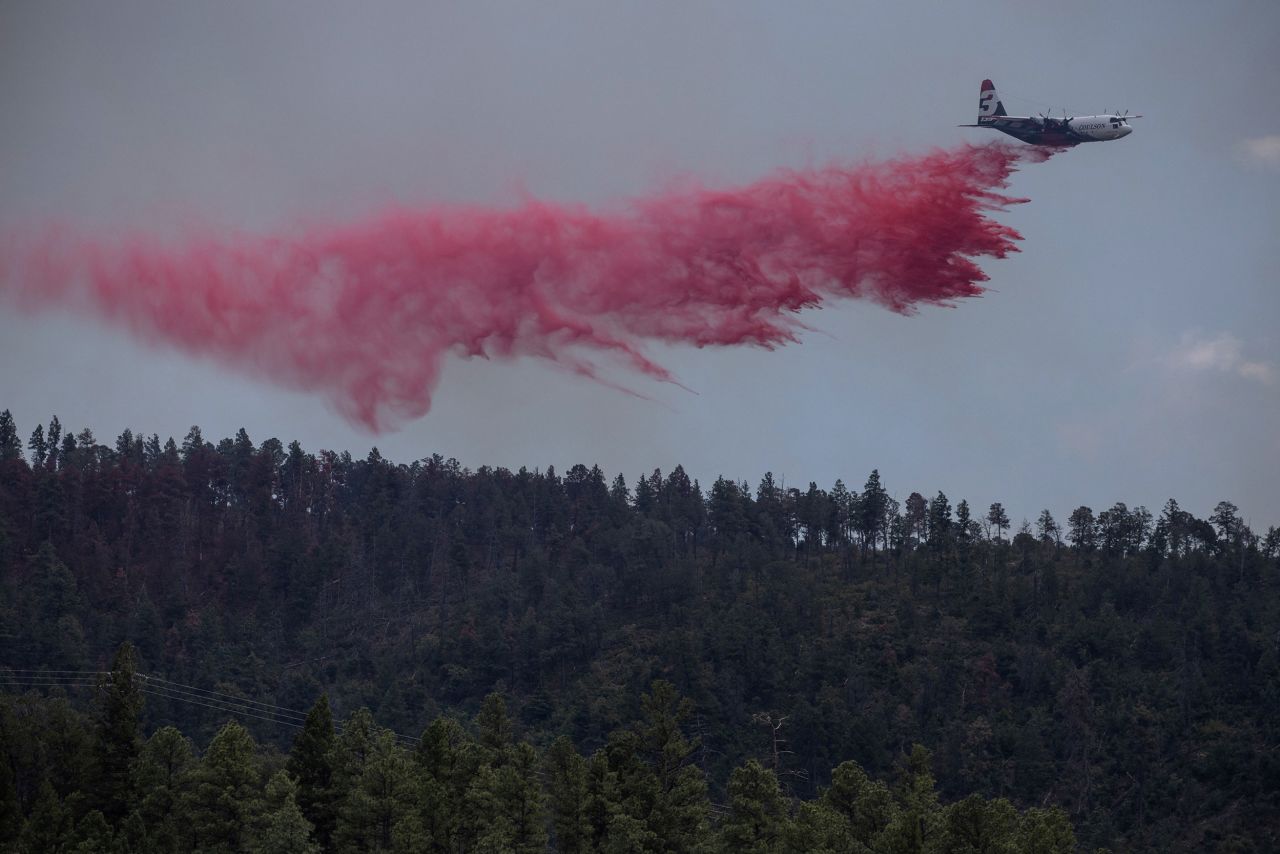 An airtanker drops fire retardant over the Salt fire as it nears the town of Ruidoso, New Mexico, on June 19. 