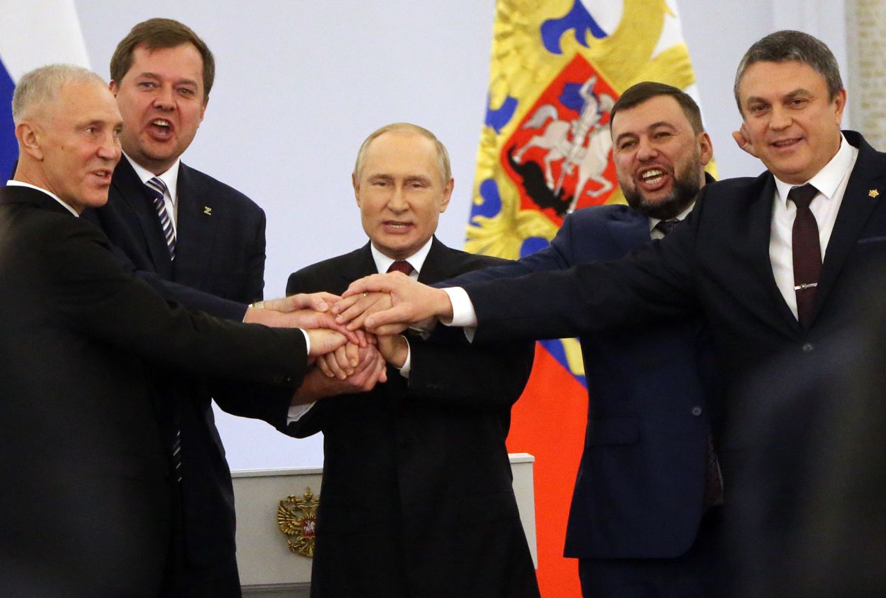 Russian President Vladimir Putin, center, with Ukrainian separatist regional leaders Vladimir Saldo, left, Yevgeniy Balitsky, second left, Leonid Pasechnik, right, and Denis Pushilin, second right, seen during the annexation ceremony of four Ukrainian regions at the Grand Kremlin Palace, September 30, in Moscow, Russia. 