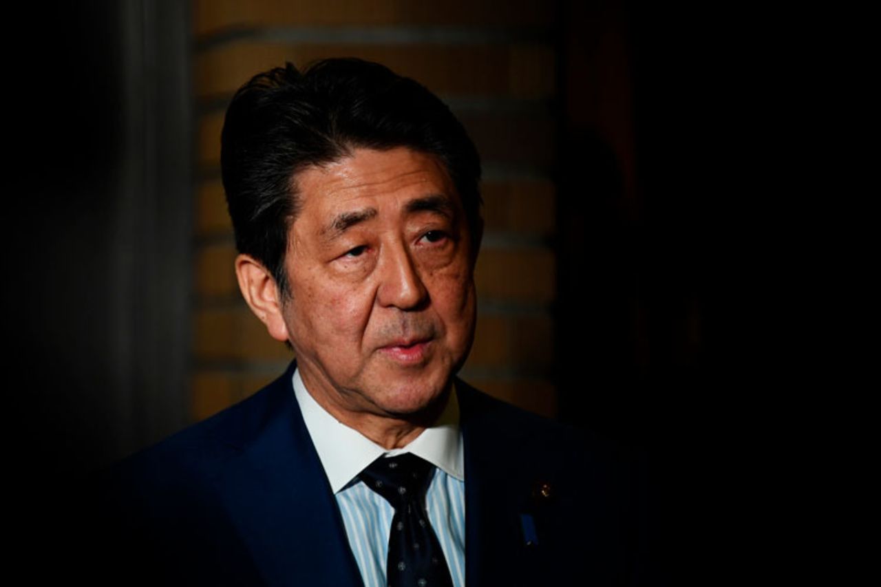 Japan's Prime Minister Shinzo Abe talks to journalists in front of the prime minister's residence in Tokyo, Tuesday, March 24, 2020.