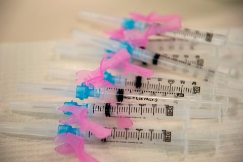 Syringes ready for vaccine use sit on a table at the East Boston Neighborhood Health Center (EBNHC) in Boston, Massachusetts on December 24, 2020. 