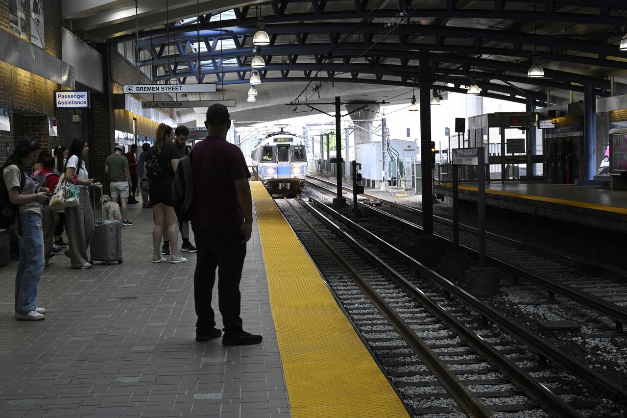 Commuters wait to ride on a Massachusetts Bay Transportation Authority subway on July 8 in Boston.