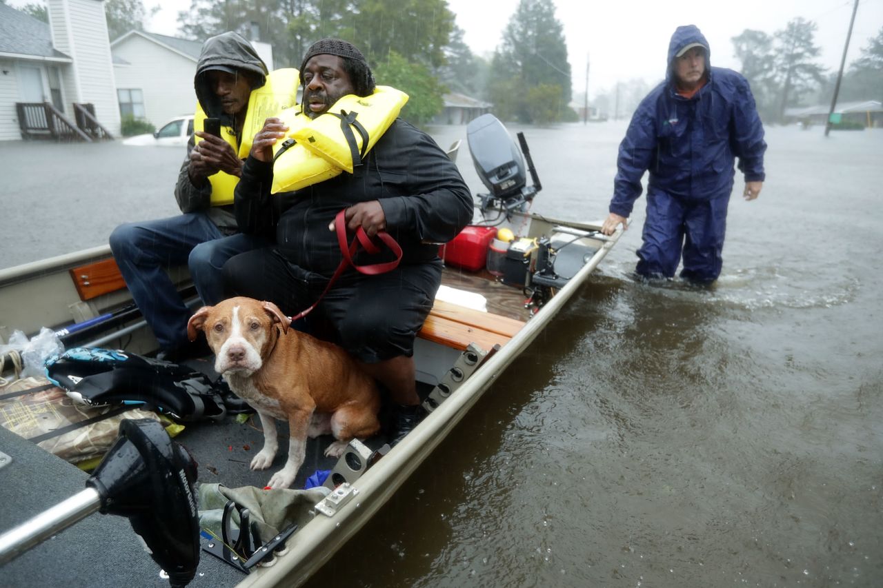 Volunteers from all over North Carolina help rescue residents and their pets from their flooded homes?on Friday.