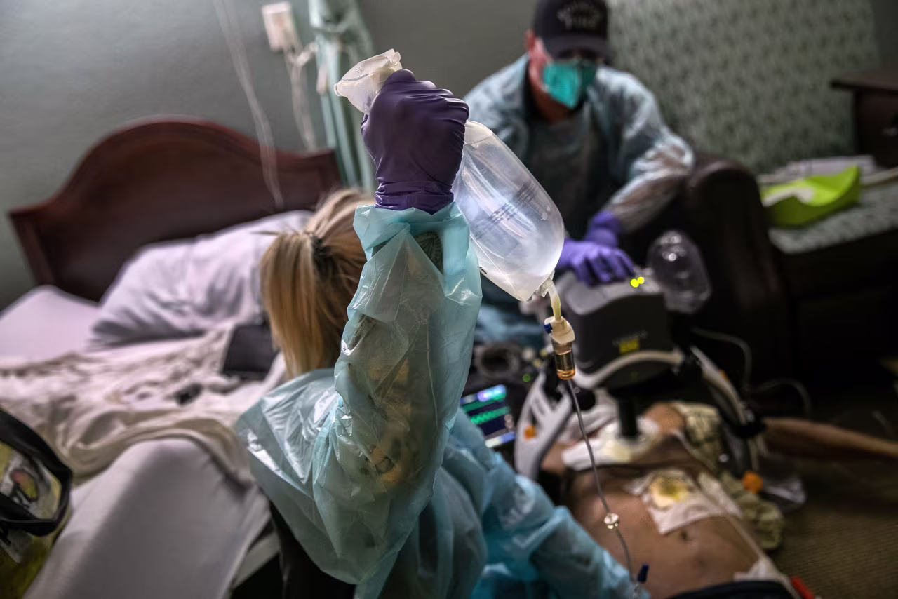 EMS medics from the Houston Fire Department try to save the life of a nursing home resident in cardiac arrest on August 12, 2020 in Houston, Texas. Heart failure, especially in seniors, is a common result of Covid-19 and medics treat most such cases as if they are Covid-positive. 