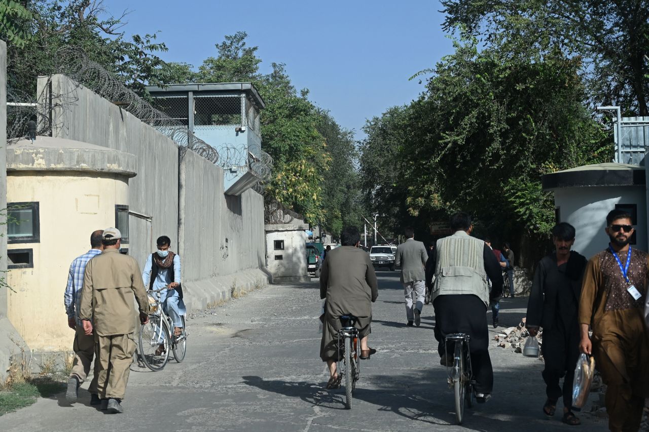 Afghan men walk through a sreet in the Green Zone of Kabul on Sunday.