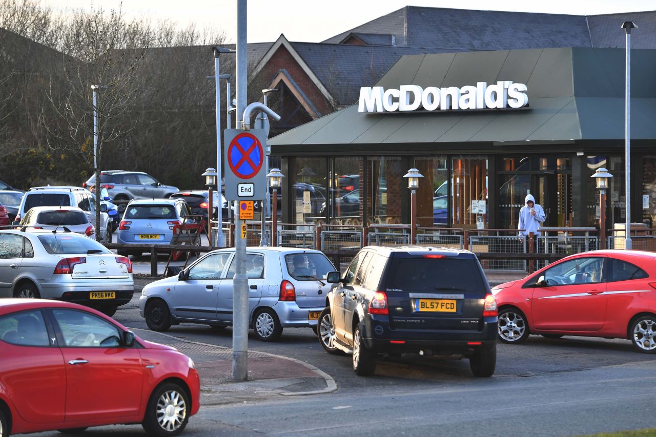 People queue outside a McDonalds restaurant in Hattersley, England, on March 23, after the chain announced it would close its restaurants.  