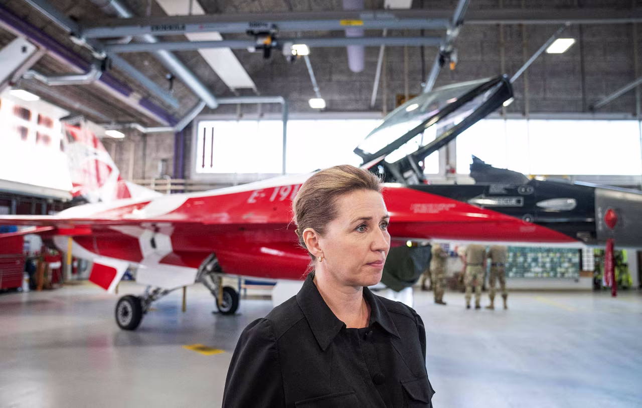 Danish Prime Minister Mette Frederiksen stands in front of an F-16 fighter jet in the colors of the Danish flag as she visits the Fighter Wing Skrydstrup Air Base near Vojens, Denmark, on May 25.