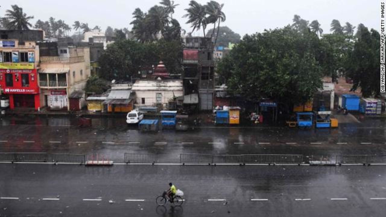 A commuter bikes down a deserted road in Puri on May 3 as the storm nears.