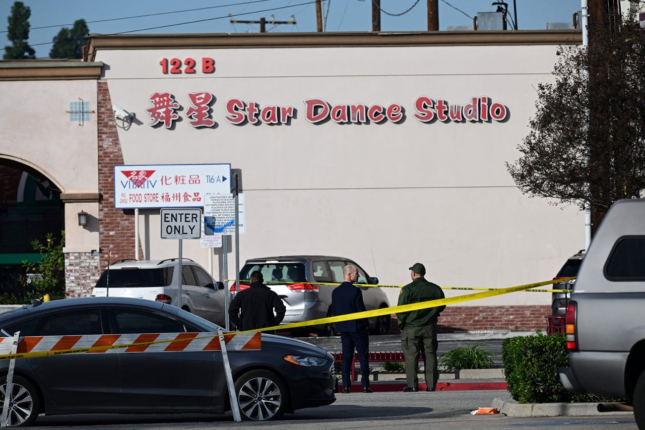 Investigators survey the scene outside the Star Ballroom Dance Studio.