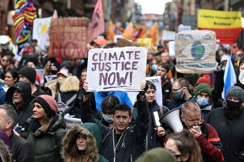 People participate in a protest rally during a global day of action on climate change in Glasgow on November 6, 2021, during the COP26 UN Climate Change Conference. 