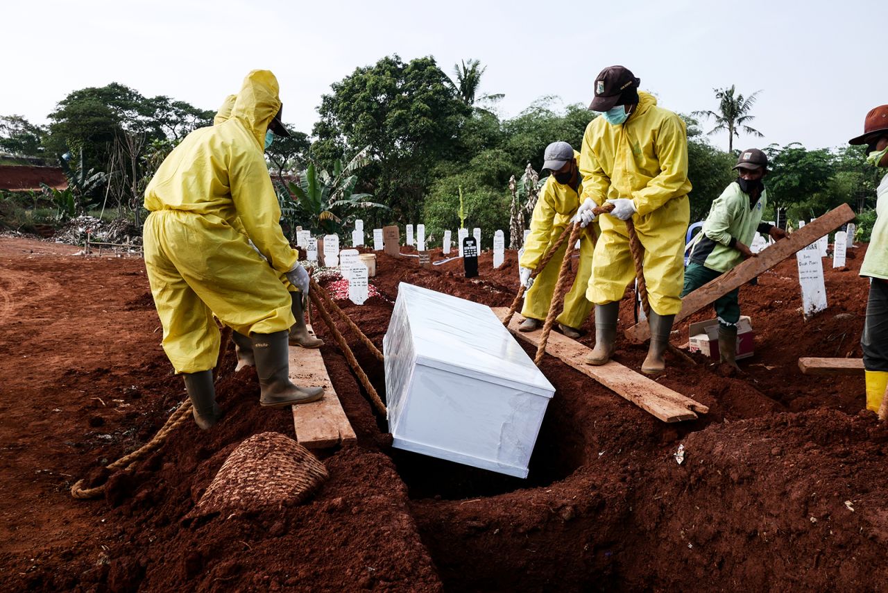 Funeral workers wearing protective suits bury a Covid-19 victim at Pondok Ranggon cemetery in Jakarta, Indonesia, on September 9. 