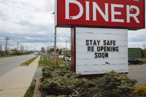 A sign saying "Stay Safe, Re-Opening Soon!" is displayed outside a diner in Amsterdam, New York, on May 15.