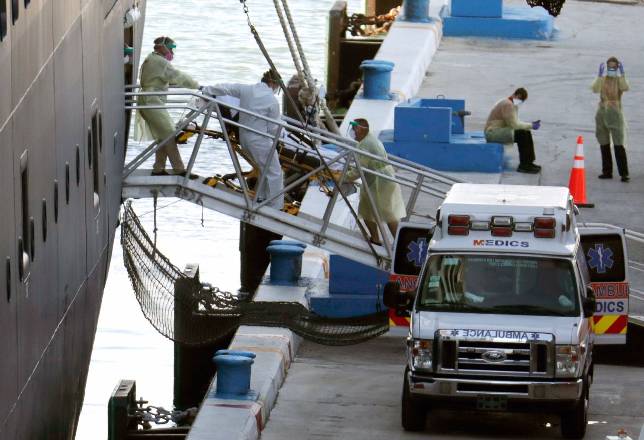 Medical workers remove a person on a stretcher from Holland America's Zaandam cruise ship in Fort Lauderdale, Florida on April 2.