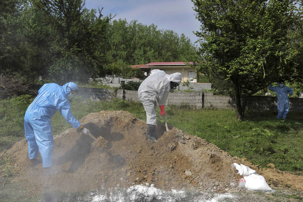 People wearing protective clothing take part in the funeral of a victim who died from coronavirus at a cemetery in Ghaemshahr, Iran, on May 1.